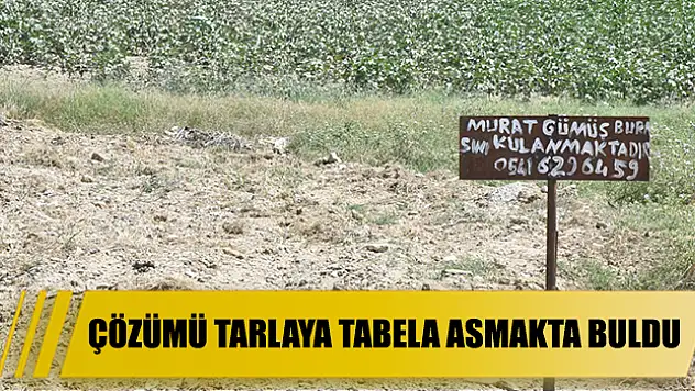 Çözümü tarlaya tabela asmakta buldu